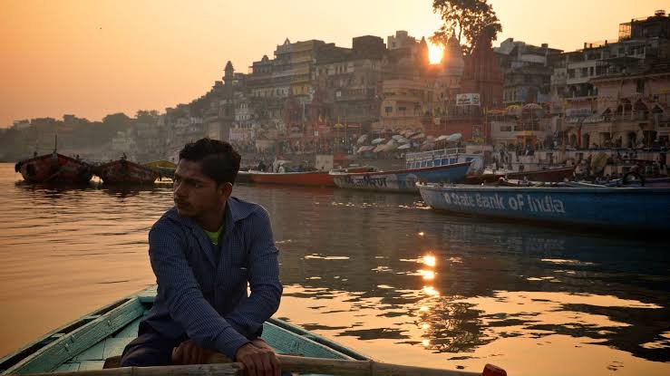 a man in a boat on water